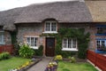 Adare, County Limerick, Ireland: traditional thatched cottage with front garden Royalty Free Stock Photo