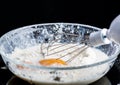 Add eggs and flour to a transparent bowl for making batter.