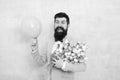Add holiday cheer with this festive bouquet. Bearded man hold tulips and balloon. Holiday celebration. Happy valentines