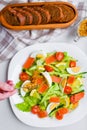 Add mustard to vegetable salad. vegetable salad with human hands. on a white plate. add spices Royalty Free Stock Photo