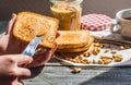 Add to ruddy toast peanut butter, hand, delicious breakfast Royalty Free Stock Photo