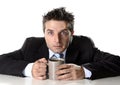 Addict businessman holding cup of coffee anxious and crazy in caffeine addiction