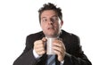 Addict businessman in suit and tie holding cup of coffee as maniac in caffeine addiction