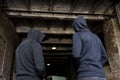 Addict men or criminals in hoodies on street