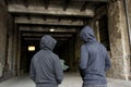 Addict men or criminals in hoodies on street