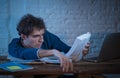 Addicted to internet young man hooked on the computer laptop late at night Royalty Free Stock Photo