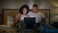 Addicted computer internet couple happy family girlfriend and boyfriend African American man and woman using laptop Royalty Free Stock Photo