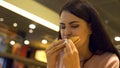 Addicted to fast food lady eating hamburger in restaurant, hungry student snack Royalty Free Stock Photo