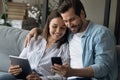 Addicted to modern tech happy couple using gadgets. Royalty Free Stock Photo