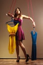 Addicted to shopping woman girl marionette with clothes Royalty Free Stock Photo