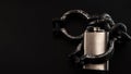 Addiction, alcoholism and alcohol abuse concept with close up on a metal flask containing an alcoholic drink shackled in iron Royalty Free Stock Photo