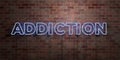 ADDICTION - fluorescent Neon tube Sign on brickwork - Front view - 3D rendered royalty free stock picture