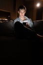 Addiction to gadgets. Young European man with a phone at night. Guy user of wireless Internet and mobile communications