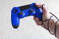Addiction to video games concept, blue game pad with wrapped hand
