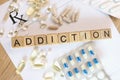 Addiction word collected with wooden cubes and medicines