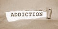 Addiction word under Brown torn paper . Stop smoking quit drinking refuce gaming and gambling concept