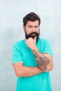 Adding care to his moustache. Serious guy wear long beard and moustache. Bearded man with stylish moustache shape Royalty Free Stock Photo