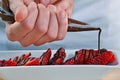 Adding dark chocolate cream on strawberries. Royalty Free Stock Photo