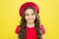 Adding an edge to the classic French look. Small child smiling with fashion look. Happy little girl wearing red beret