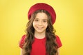 Adding an edge to the classic French look. Small child smiling with fashion look. Happy little girl wearing red beret
