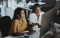 Adding final touches to their big plan. two young businesswomen working together on a computer in an office at night. Royalty Free Stock Photo