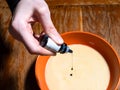 Adding green food coloring in bowl of liquid dough Royalty Free Stock Photo