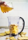 Adding honey into a blender with fruit Royalty Free Stock Photo