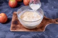 Adding milk to the mixture of sugar, butter, flour and eggs Royalty Free Stock Photo