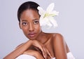 Adding more natural beauty. Studio shot of a beautiful african american woman with an orchid in her hair.