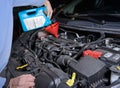 Adding motor oil to a car engine during maintenance Royalty Free Stock Photo