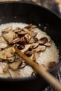 Adding porcini mushrooms in a risotto dish Royalty Free Stock Photo