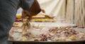 Adding seafood to huge frying pans in preparing a giant paella. Royalty Free Stock Photo