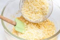 Adding shredded cheese to prepare sweet corn bread Royalty Free Stock Photo