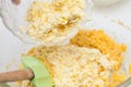 Adding shredded corn kernels to prepare sweet corn bread Royalty Free Stock Photo