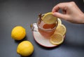 Adding slice of lemon to lemon tea drink