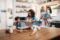 Adding some fruitiness. a young family spending quality time together in the kitchen at home. Royalty Free Stock Photo