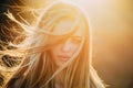 Adding volume to her long hair. Sensual woman with wavy long hair outdoor. Pretty girl with beautiful healthy hair in Royalty Free Stock Photo