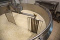 Adding water to curd and whey in tank at cheese factory