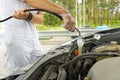 Adding windshield washer fluid at gasolin station by driver. Close-up of adding windshield washer fluid on a car. car Royalty Free Stock Photo