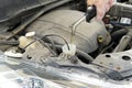 Adding windshield washer fluid at gasolin station by driver. Close-up of adding windshield washer fluid on a car. car