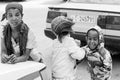 Three small orphan street kids playing and laughing on a quite c Royalty Free Stock Photo