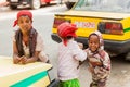 Three small orphan street kids playing and laughing on a quite c