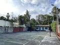 Addis Ababa-Ethiopia, October 27, 2023: Outdoor badminton, basketball, futsal, volleyball and tennis court next to old building Royalty Free Stock Photo