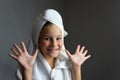 Addorable little girl happy smiling after spa bath on a white bath towel head Royalty Free Stock Photo