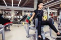 Adduction or abductor machine. girl exercising her legs in gym