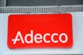 Adecco logo on a wall. Adecco Group, based near Zurich, Switzerland, is the largest staffing firm in the world