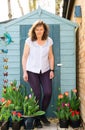 Adele by the shed, with butterflies and tulips.