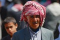 Portrait of unidentified senior man wearing traditional head scarf at the street in Aden, Yemen.