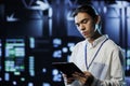 Programmer in data center with tablet Royalty Free Stock Photo