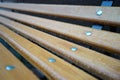 Adetail of wooden bench in the rain